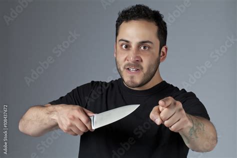 an angry man holding a knife Stock Photo | Adobe Stock