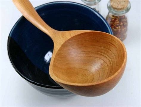 two wooden spoons sitting next to each other on top of bowls and jars ...