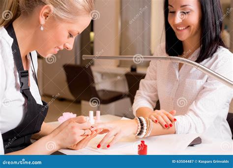 Happy women doing manicure stock image. Image of finger - 63504487