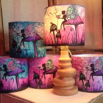several lamps with different designs on them sitting on a table