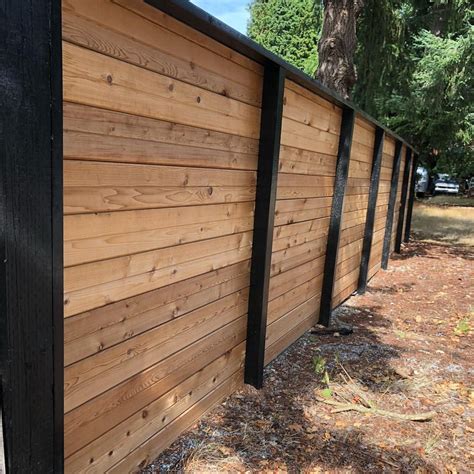 Horizontal fence with black frame black posts | Horizontal fence, Backyard fences, Fence design