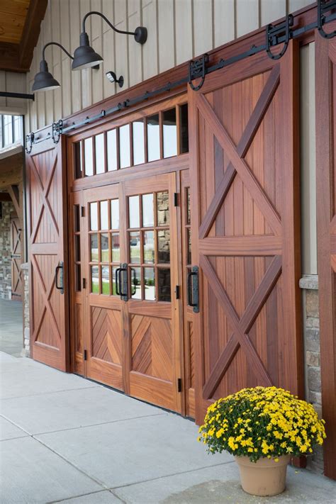 a potted plant with yellow flowers sitting in front of a wooden door and windows