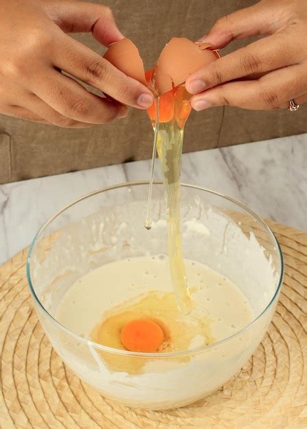 Premium Photo | Cracked egg on flour batter step by step baking