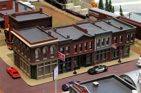 a model town is shown with cars and buildings