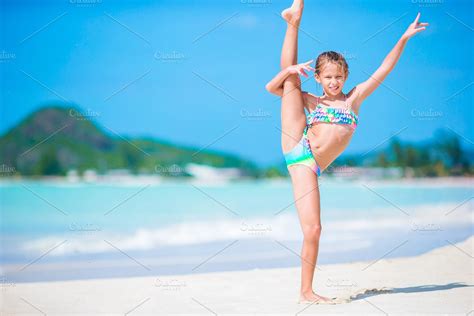 Beautiful little girl on beach having fun. Happy girl enjoy summer vacation background the blue ...