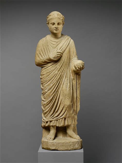 Limestone statue of a wreathed boy holding a ball or piece of fruit ...