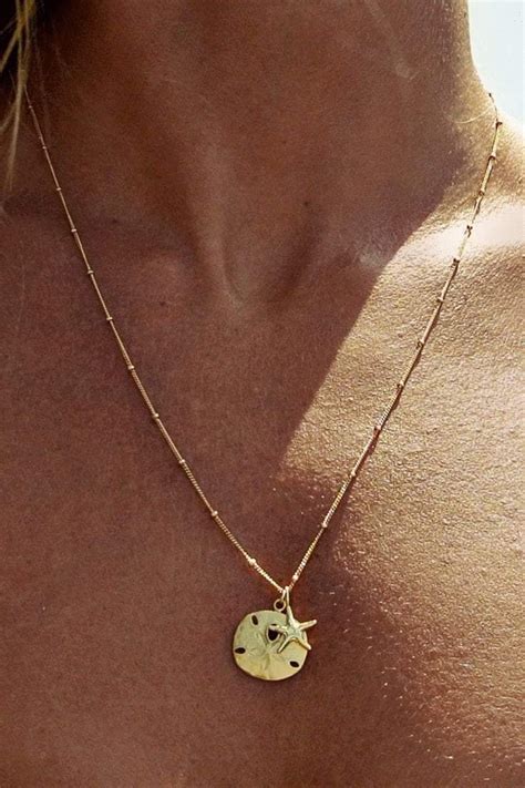 The Soleil Blue Beachcomber Sand Dollar Necklace captures the Bohemian spirit of our unique ...