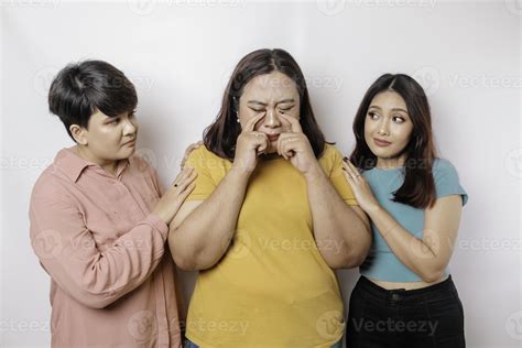 A portrait of three friends looking sad crying wiped her tears and hug ...