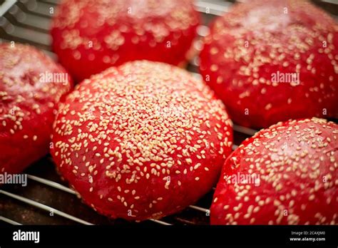 Fresh baked red homemade burger buns with sesame top view. Placed on metal grill Stock Photo - Alamy