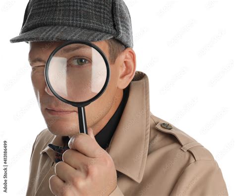 Male detective looking through magnifying glass on white background ...