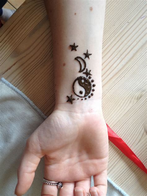 Yingyang, moon and stars Wrist henna tattoo design | Henna tattoo designs simple, Simple henna ...