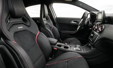 the interior of a car with black leather and red stitching