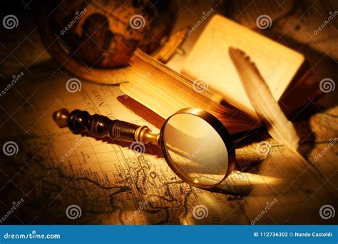 Magnifying Glass With Book, Pen And World Map On Old Map Royalty-Free ...