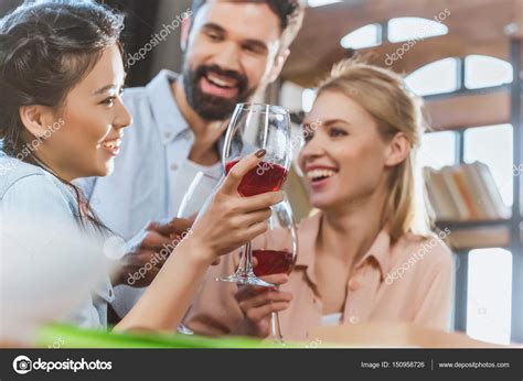 Young people drinking wine — Stock Photo © ArturVerkhovetskiy #150958726