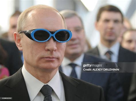 Russian Prime Minister Vladimir Putin wears glasses as he visits the ...