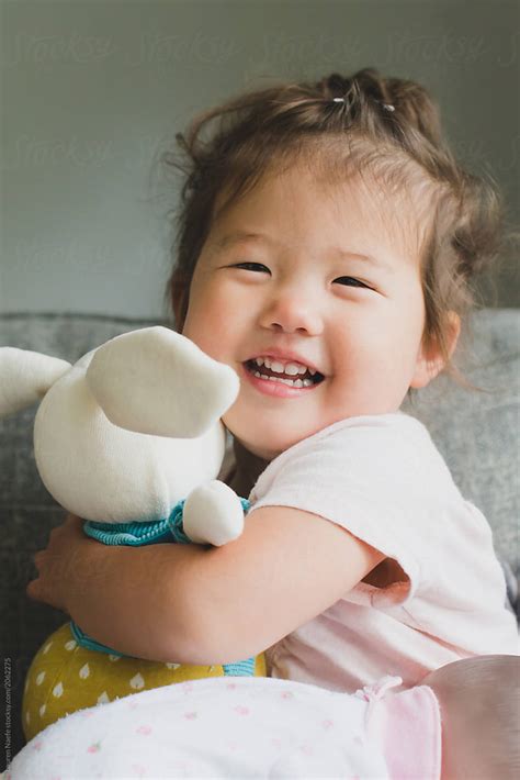 "Baby Holding Stuffed Animal" by Stocksy Contributor "Lauren Lee" - Stocksy