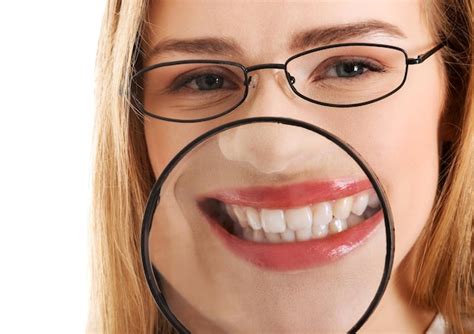 Premium Photo | Close-up portrait of smiling young woman with magnifying glass