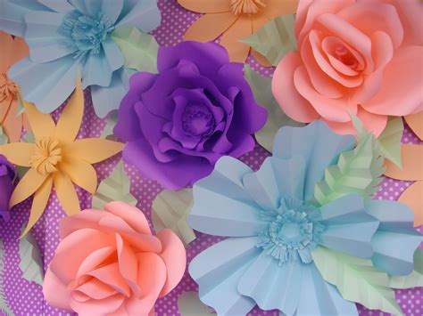 there are many different colored paper flowers on the table