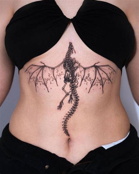 Blackwork style skeleton dragon tattooed on the