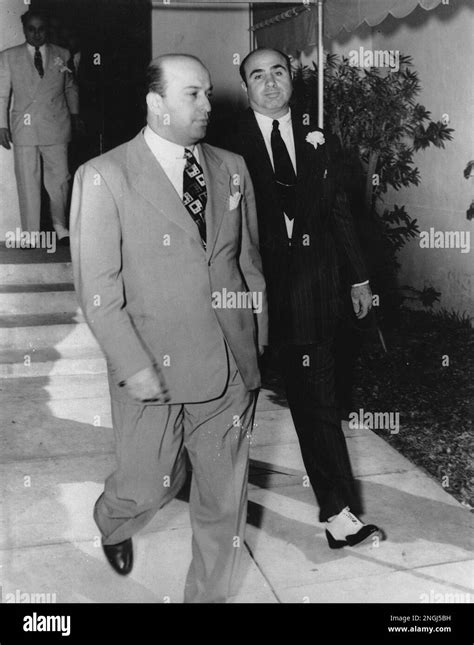 Al Capone, right, is shown in one of his last public appearances as he and his unidentified ...