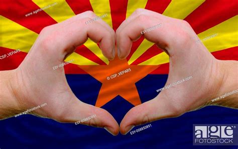Gesture made by hands showing symbol of heart and love over us state flag of arizona, Stock ...