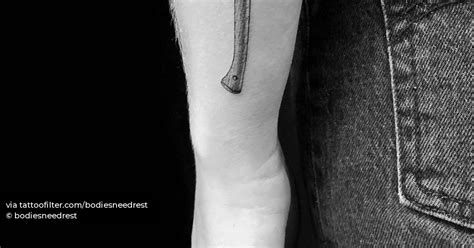 Single needle axe tattoo on the forearm