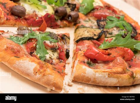 Freshly baked pizza slice - angled shot Stock Photo - Alamy