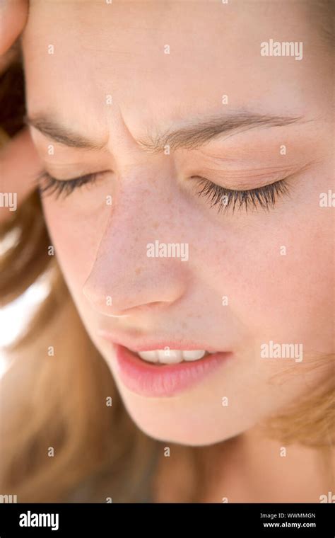 Head shot of woman scowling Stock Photo - Alamy