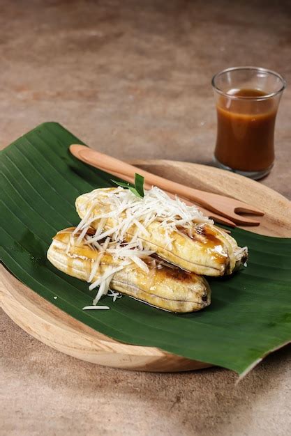 Premium Photo | Pisang gapit or pisang epe is grilled banana with coconut brown sugar sauce and ...