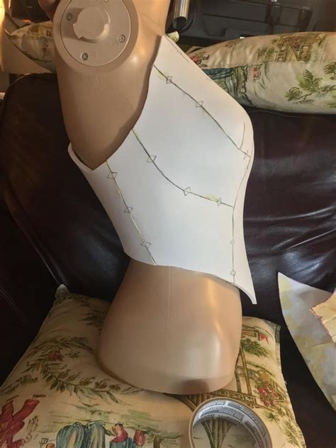 a mannequin head sitting on top of a brown leather couch next to a clock