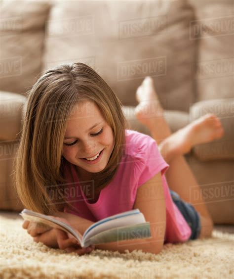 USA, Utah, Lehi, Girl (10-11) lying on rug, reading book - Stock Photo ...