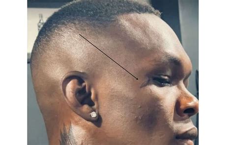 Israel Adesanya flaunts new neck tattoo, asks fans to decode its meaning