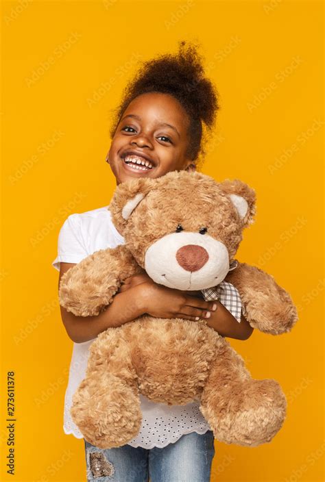 Cute african american child hugging teddy bear and smiling Stock Photo ...