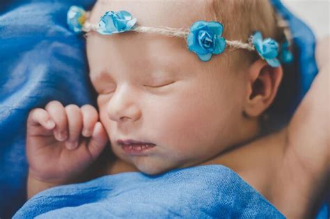 Premium Photo | Newborn baby sleeping on a blue background selective focus person