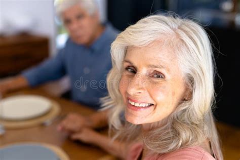 Close-up Portrait of Smiling Caucasian Senior Woman Holding Biracial Man S Hand at Dining Table ...
