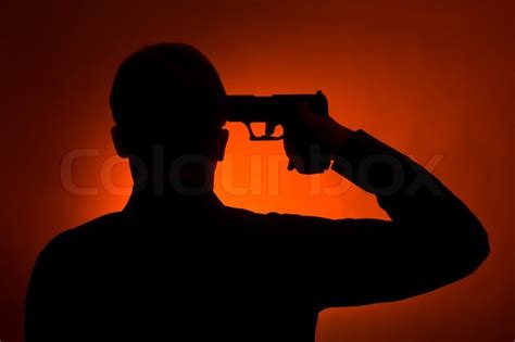 Silhouette of the man pointing gun to ... | Stock image | Colourbox