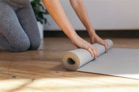 Sporty woman rolling yoga mat | Premium Photo - rawpixel