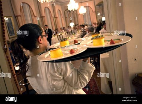 Waiter carrying tray with dishes Stock Photo - Alamy
