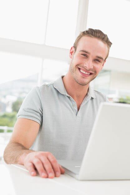 Premium Photo | Happy businessman sitting using laptop