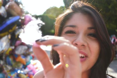Woman Doing Holding Cotton Candy In Front Of The Camera · Free Stock Photo