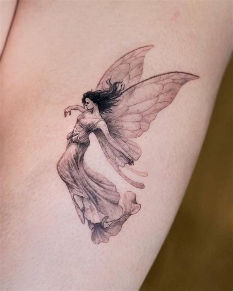 Fairy tattoo located on the thigh.