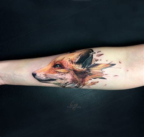 Fox head tattoo on the right inner forearm.