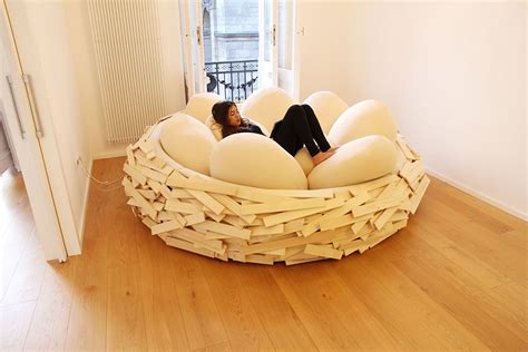 The Giant Birdnest: A Cozy Wooden Bed Filled With Egg-Shaped Pillows ...