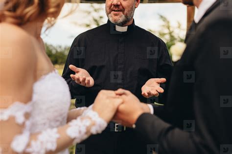 Priest giving blessings to bride and groom stock photo (141860) - YouWorkForThem