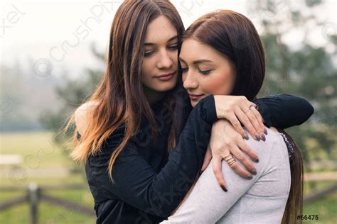 Intense portrait of young sisters hugging outdoors in a park - stock photo 66475 | Crushpixel