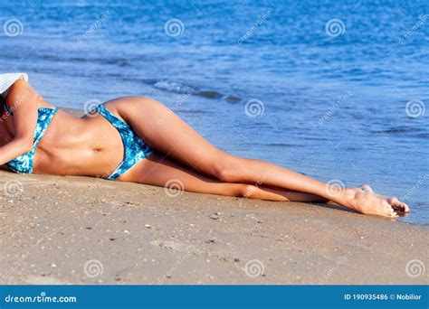 Woman is Relaxing on a Sea Sand on a Beach Stock Photo - Image of slim, lying: 190935486