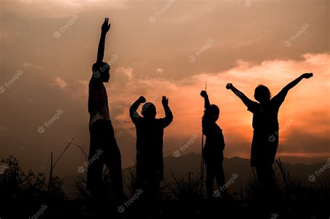 Premium Photo | Group of happy children playing on meadow at sunset ...