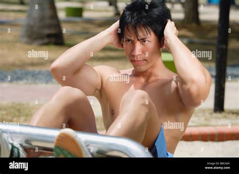 Young man doing sit ups outdoors Stock Photo - Alamy