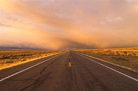 Premium Photo | Orange sunset open road two lane highway horizontal