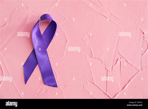 Purple ribbon on color background. Pancreatic cancer awareness concept ...